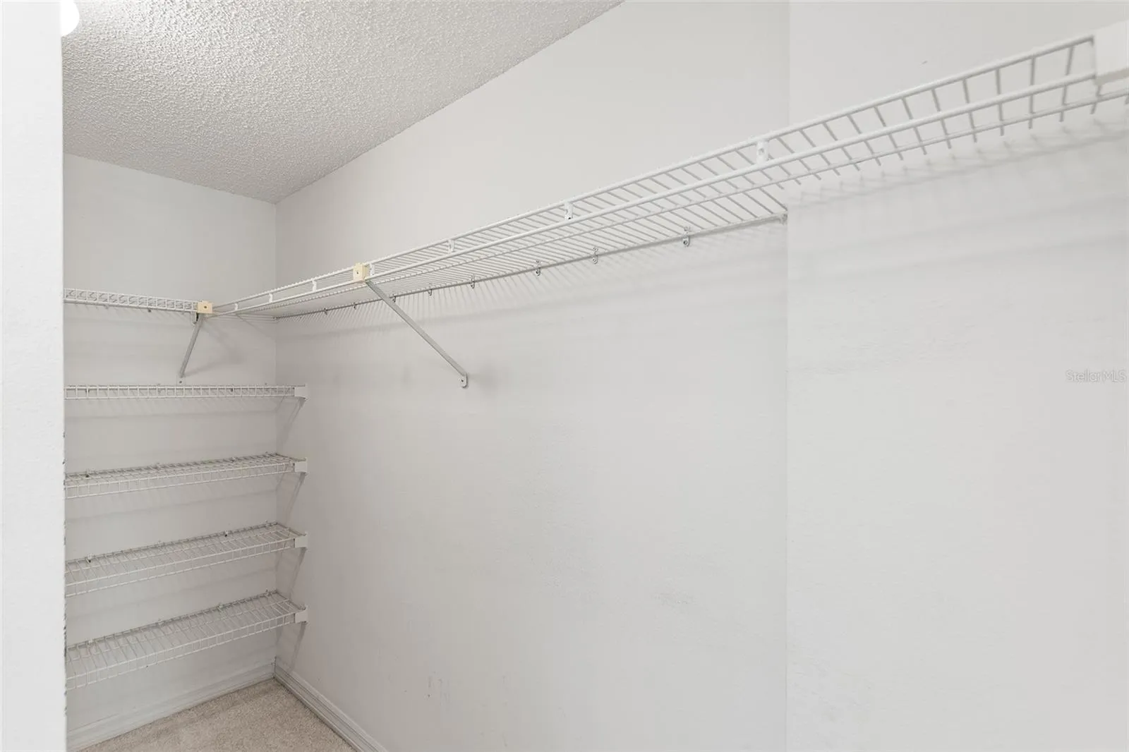 PRIMARY BEDROOM SUITE WALK-IN CLOSET