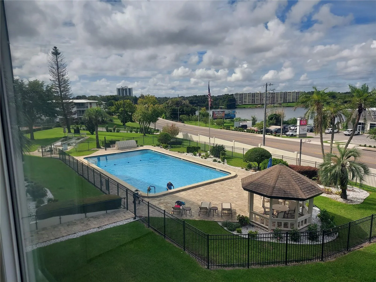 Condo view of pool and lake