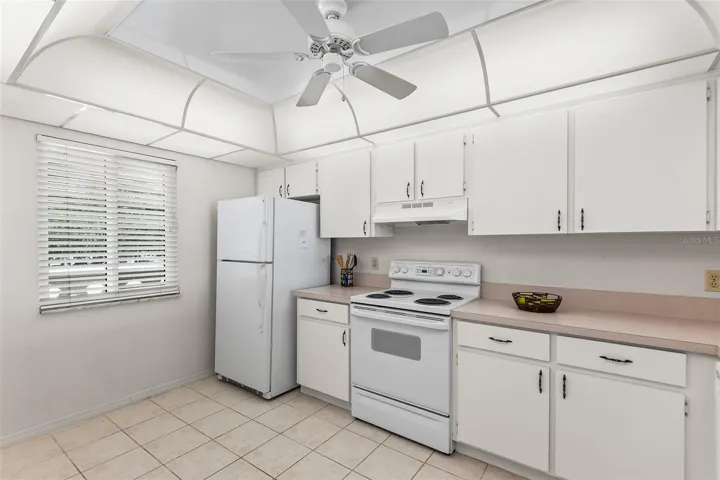 KITCHEN. NOTE EASY TO CARE FOR TILE FLOORING.