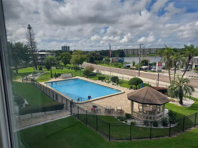 Condo view of pool and lake