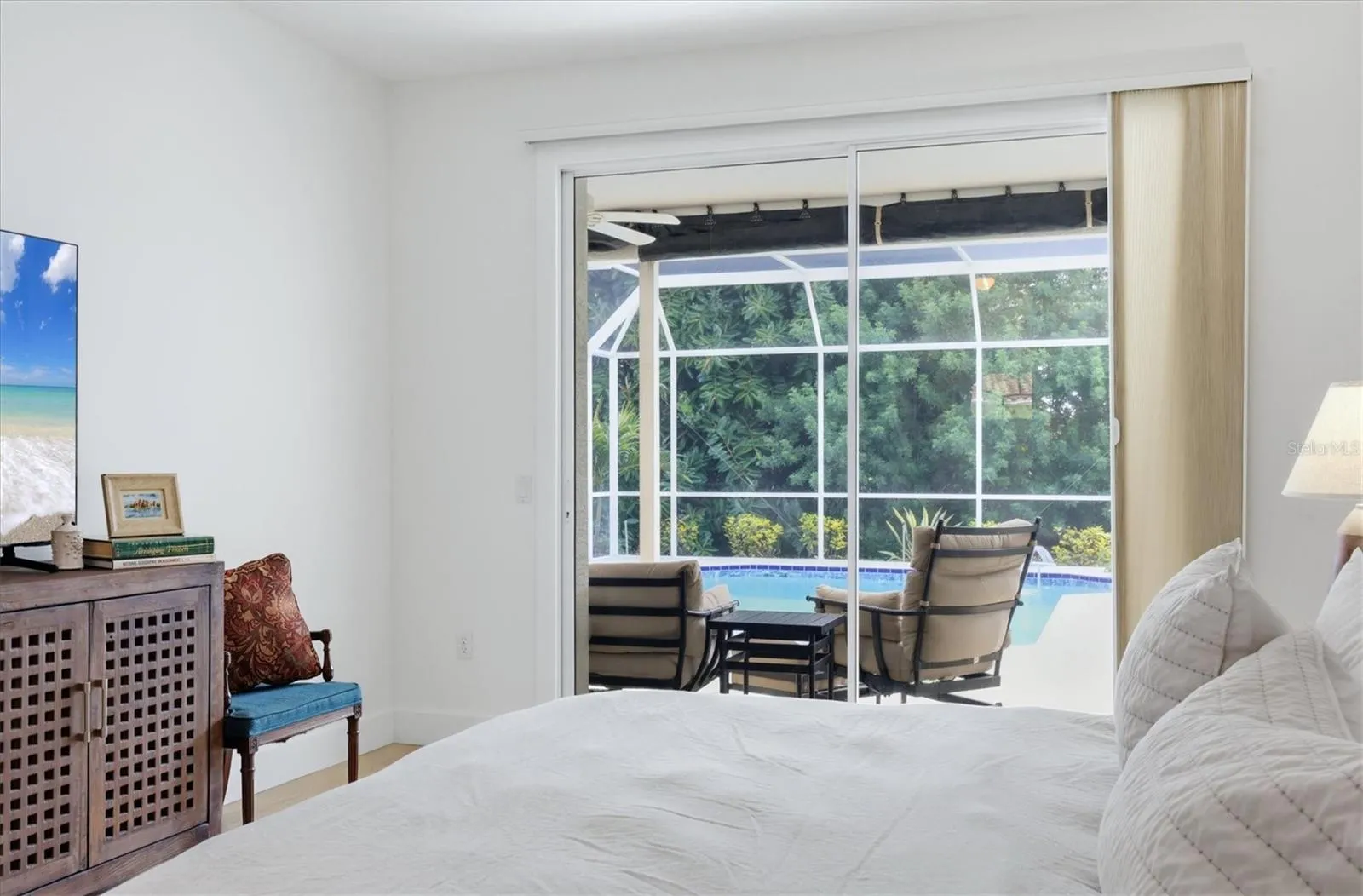 Primary bedroom with sliders to pool.