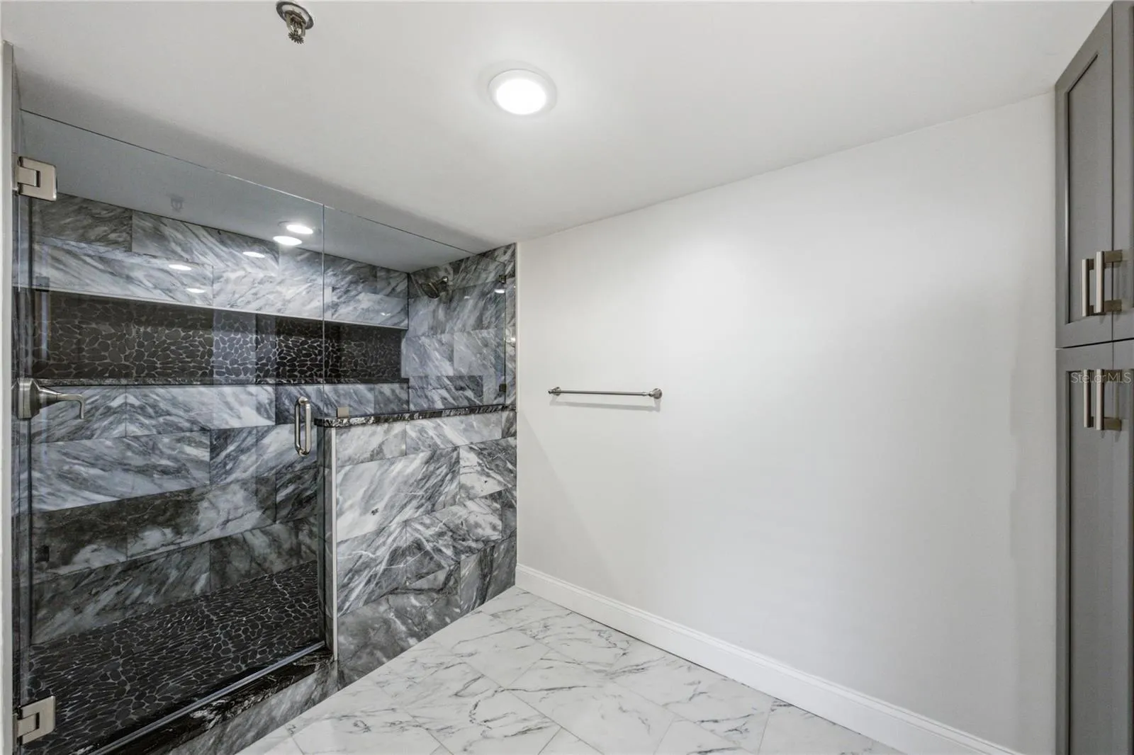 Primary bathroom with water closet and walk in shower