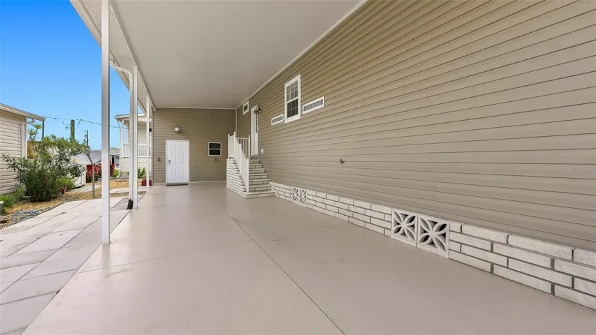 Attached storage room at far end of carport