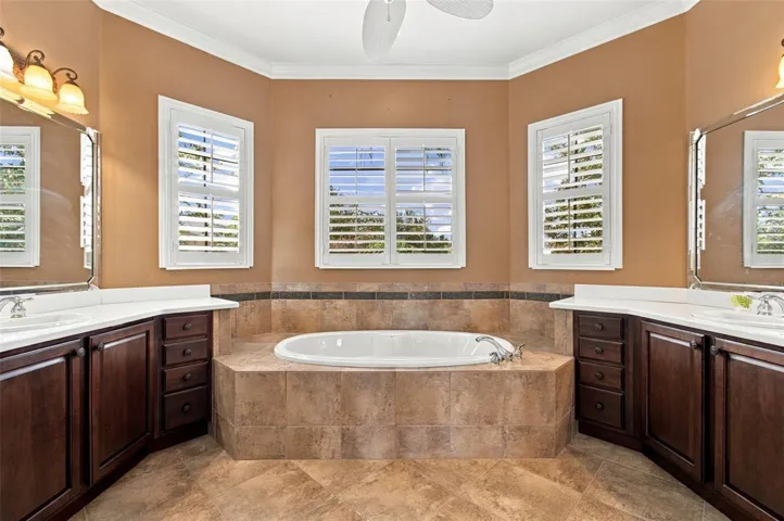 Primary en-suite bathroom with split vanities