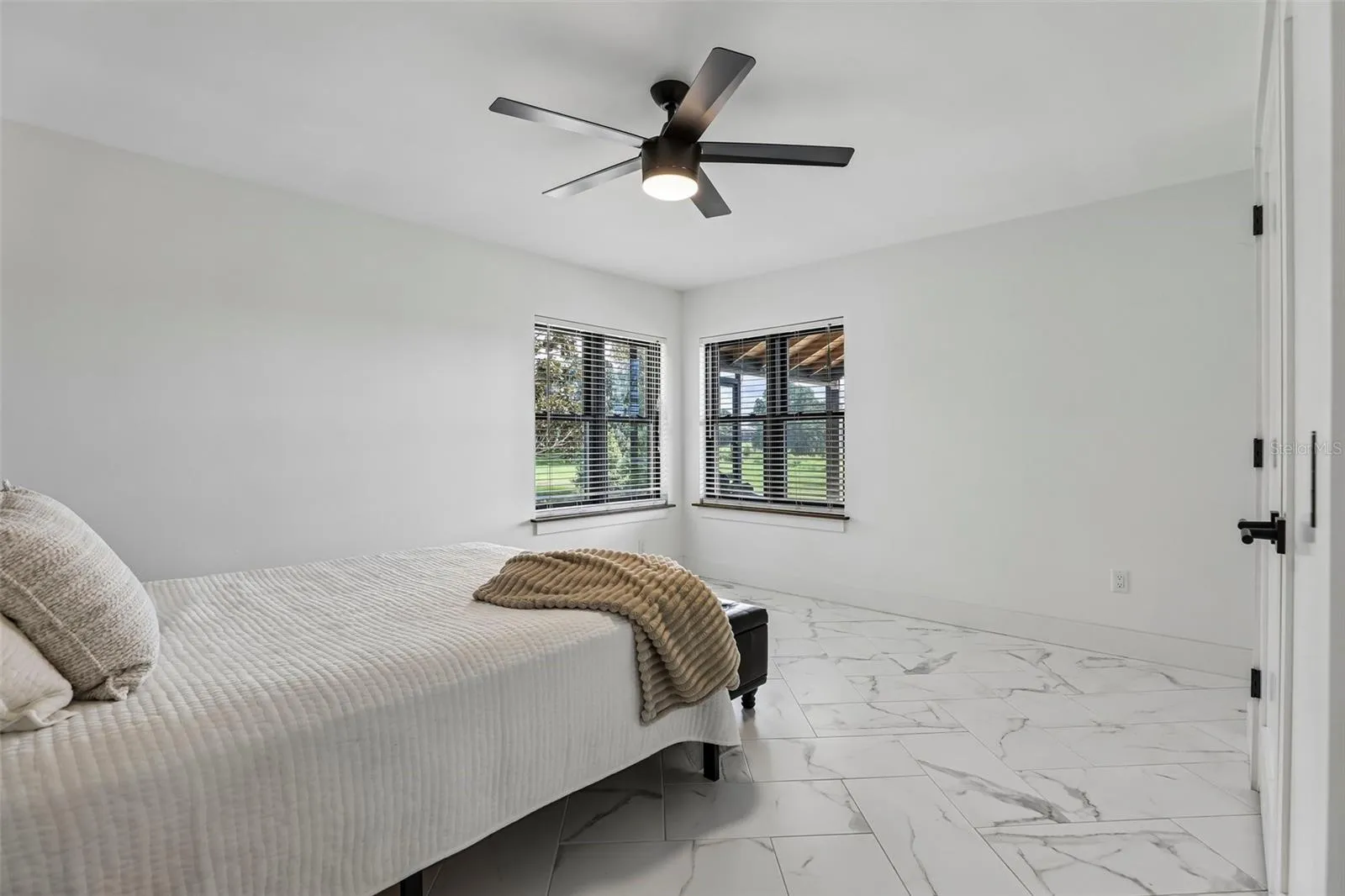 Spacious secondary bedroom 2 with corner window and oversized closet.