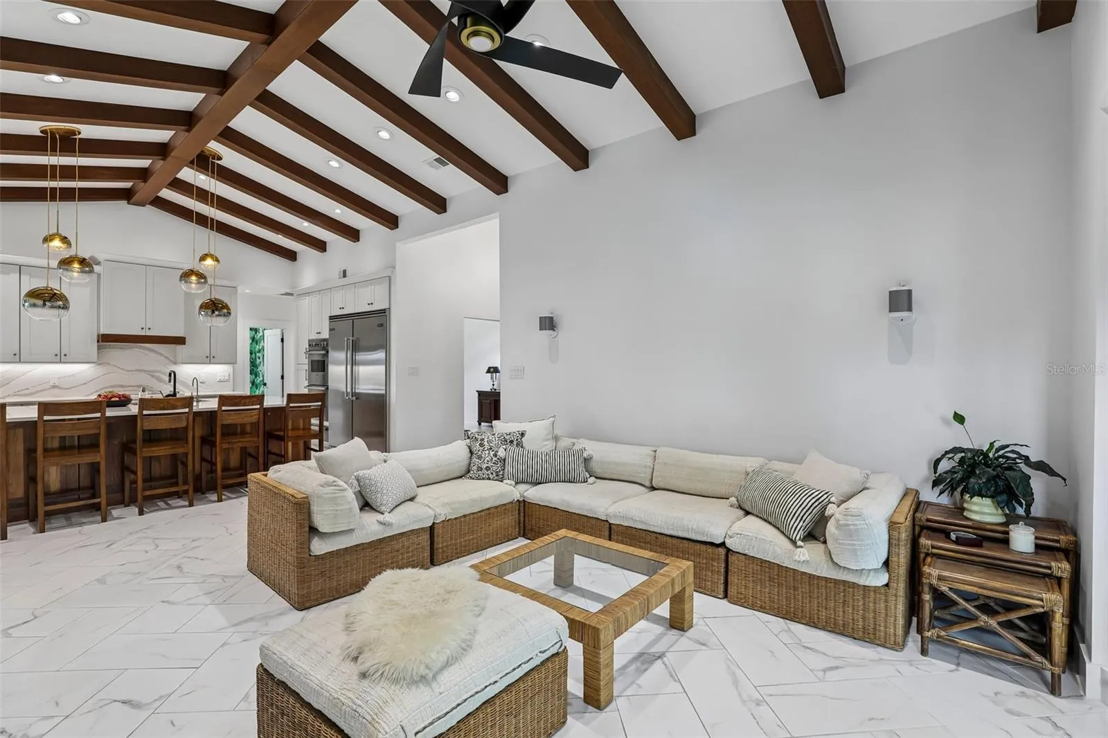 Great room soaring ceilings, wood beams and view to kitchen.