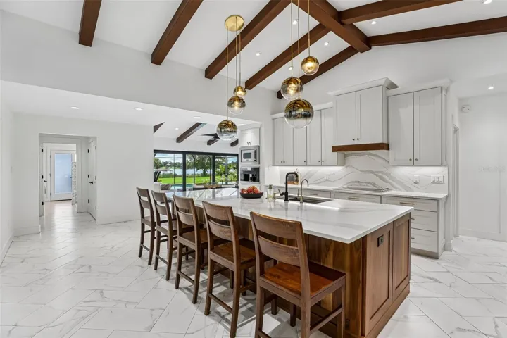 Kitchen open to sunroom lake view.