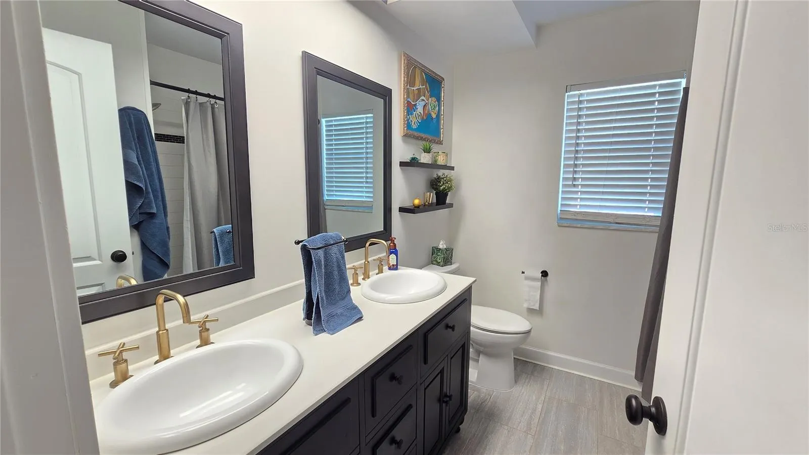 Full bathroom with shower/tub combo plus double sinks.