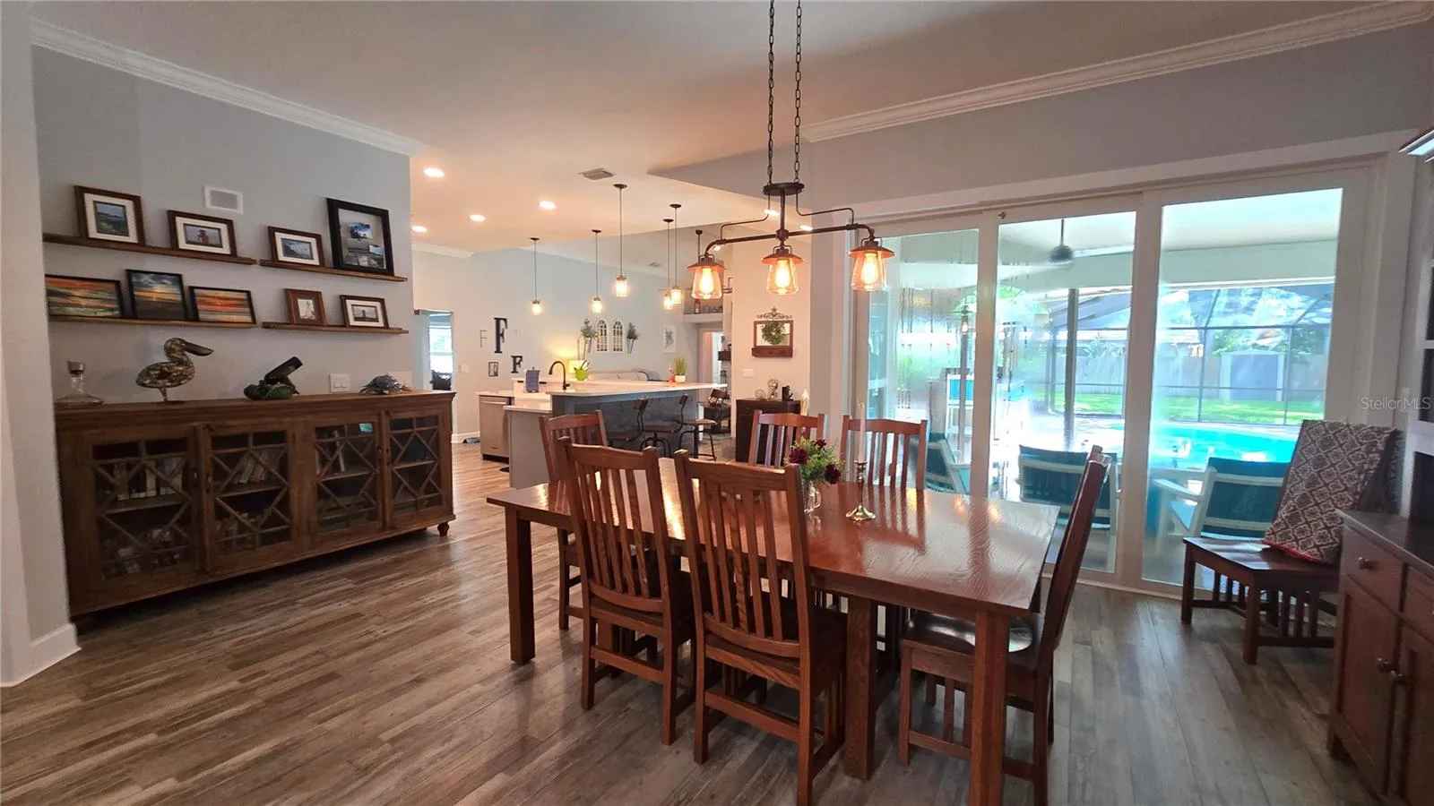 Lovely view from the dining room to the inviting pool area through the sliding glass doors.