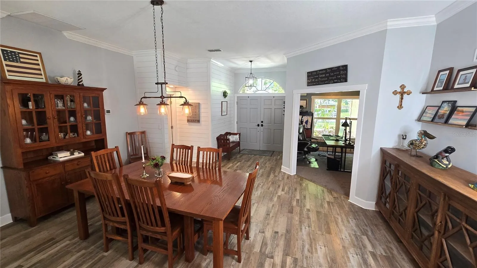 This view is from the back of the dining room facing the front entry door as well as the front office space.