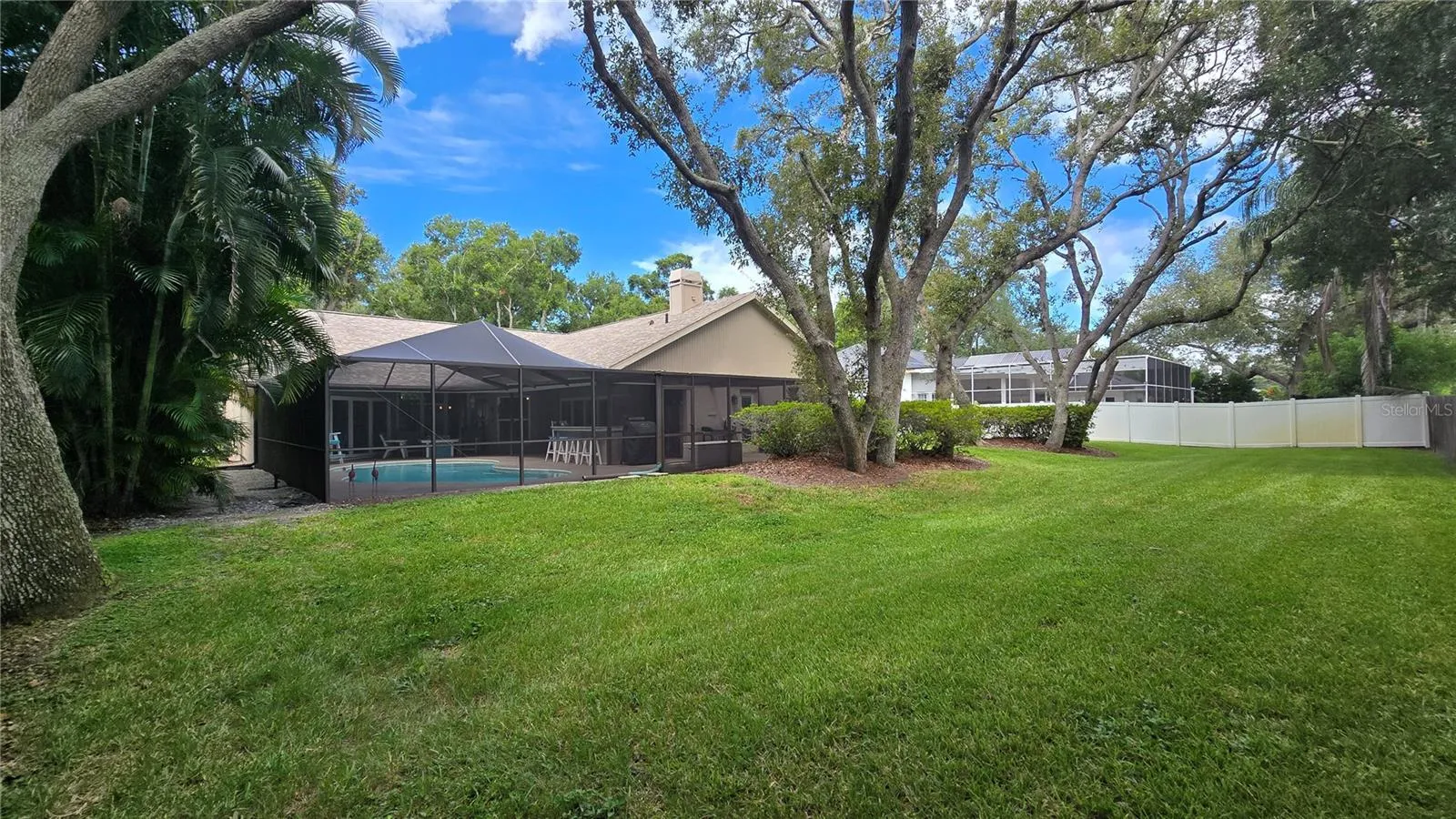 View of the pool area and the back yard.