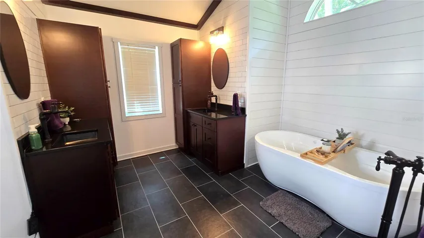 Primary Bathroom with 2 cabinets/vanity.  Don't overlook this adorable tub to relax in after a hard day at work.