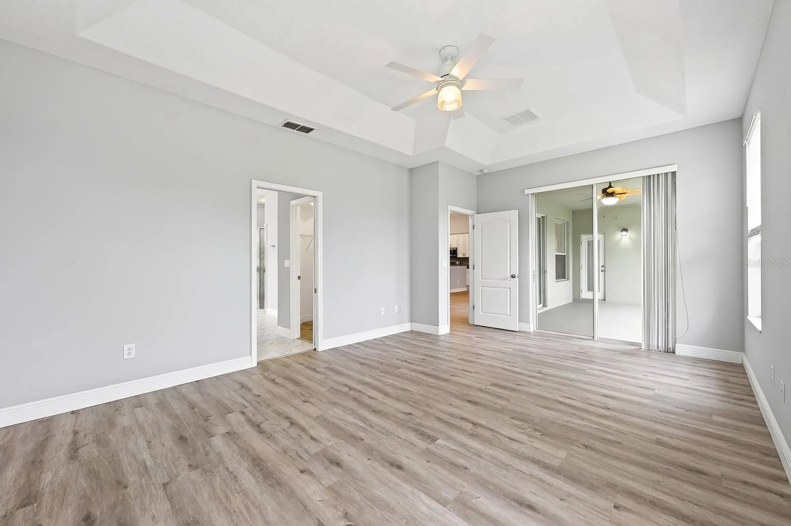 Light, bright, spacious primary suite has direct access to the lanai.