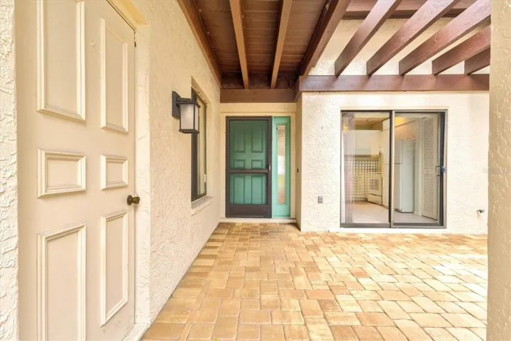 Garage door to the left, showing covered walkway to the front door