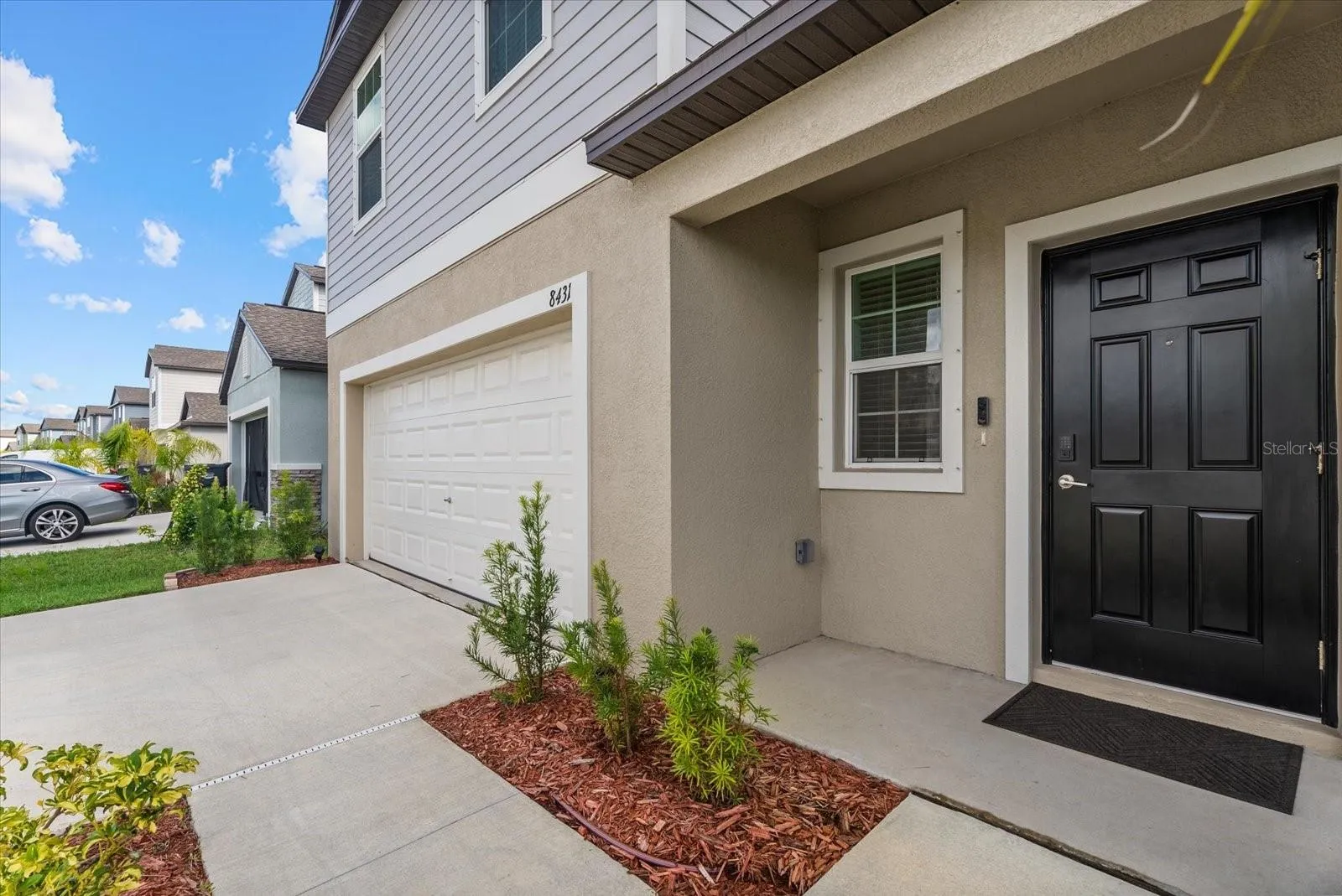 Welcoming covered entrance with a landscaped walkway and easy garage access.