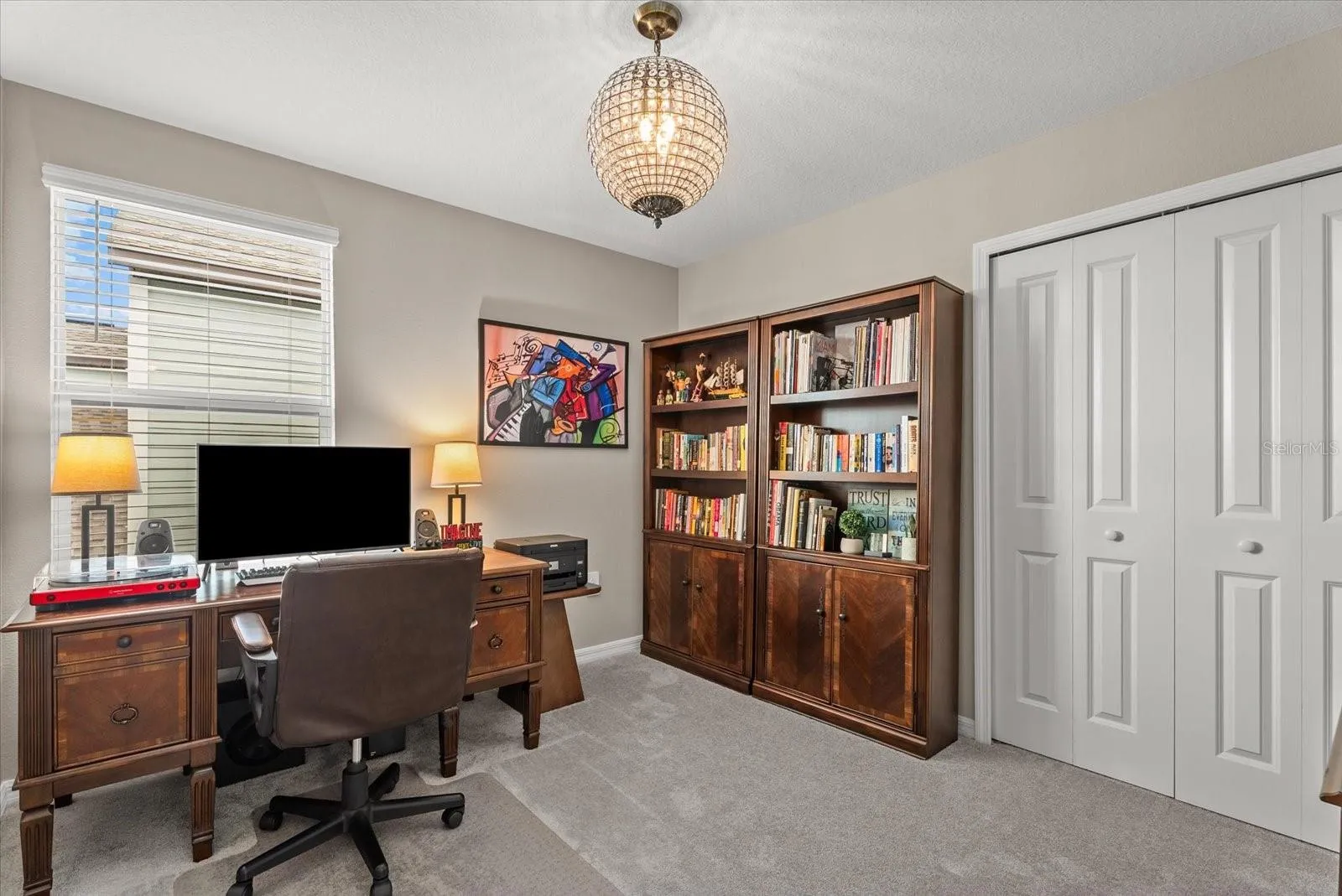 Secondary bedroom currently arranged as a comfortable home office.