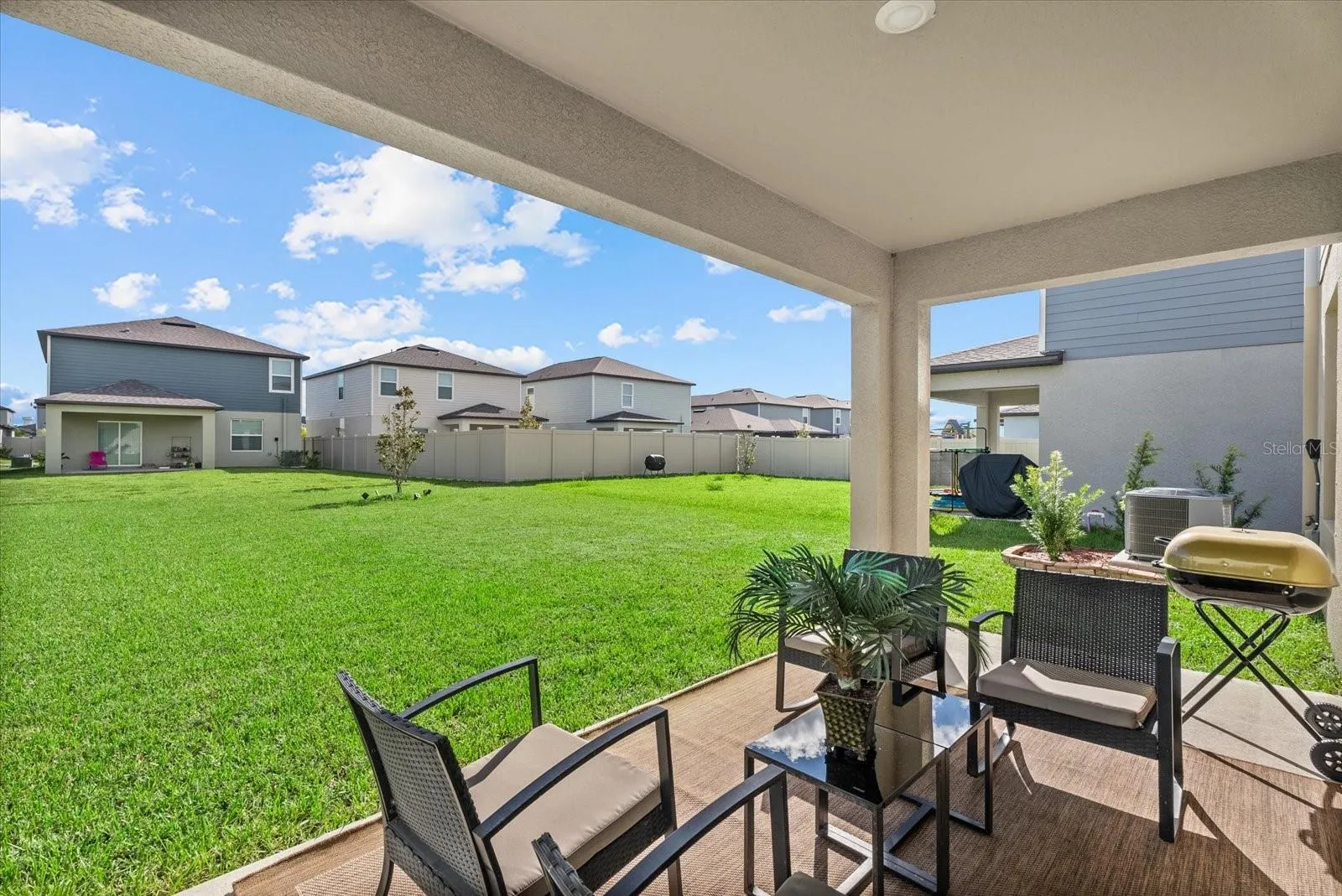 Covered rear patio overlooking the spacious backyard.