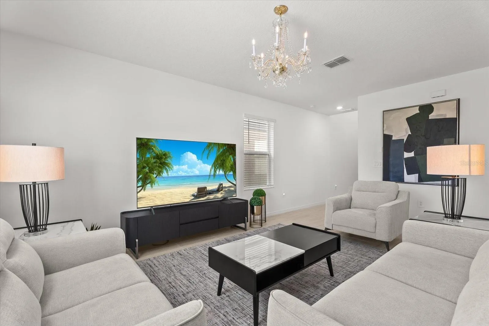 Comfortable living area featuring neutral finishes and a decorative chandelier.