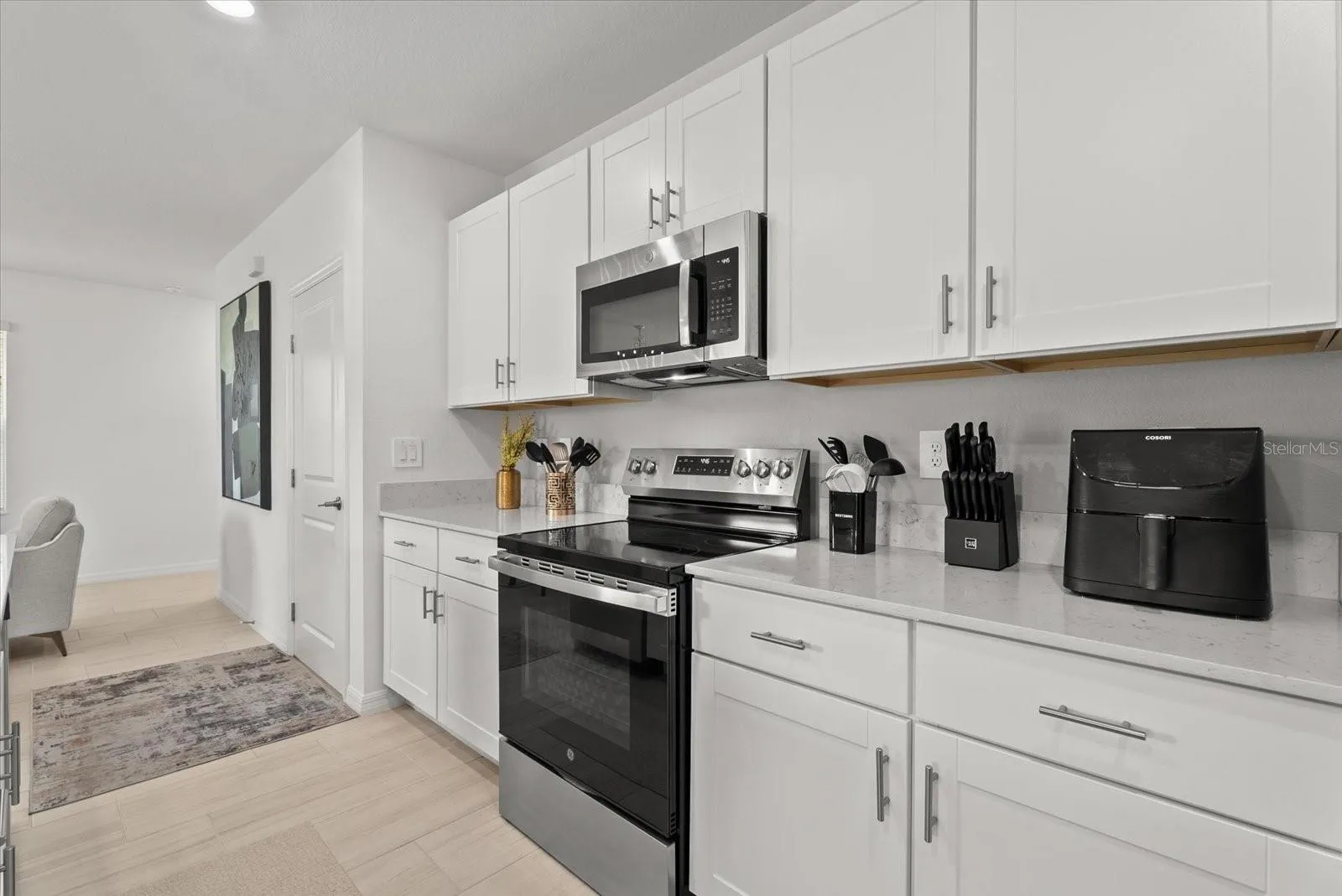 Well-appointed kitchen with abundant cabinet and countertop space.