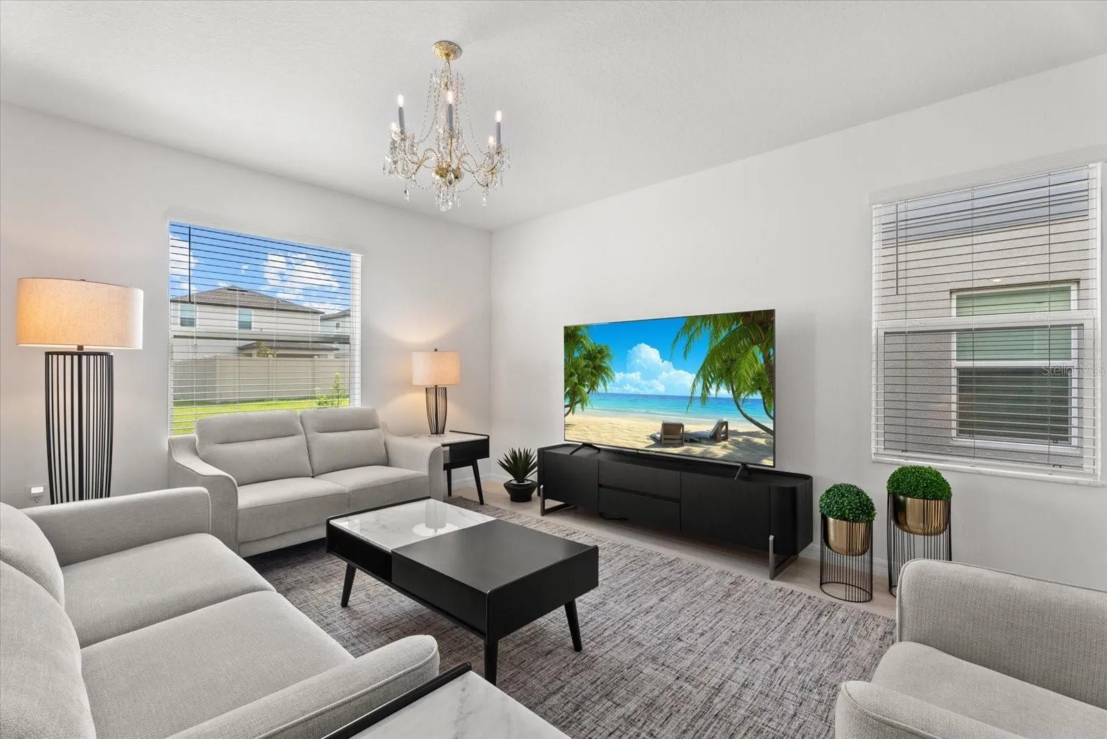 Bright living room with multiple windows and plenty of space for entertaining.