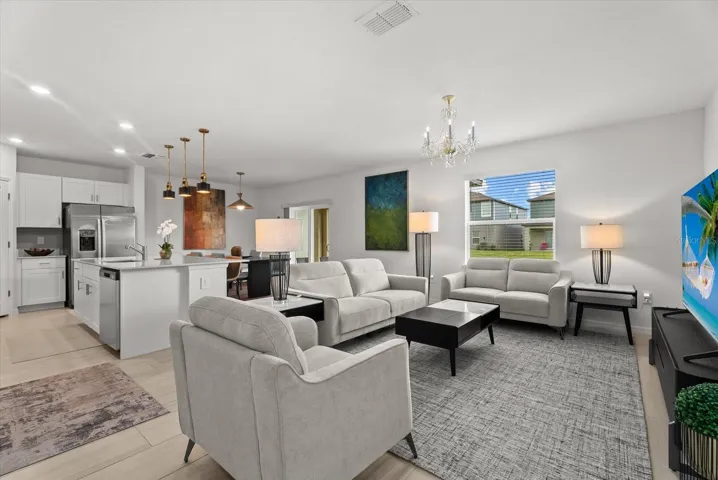 Spacious open-concept living area flowing seamlessly into the kitchen and dining space.