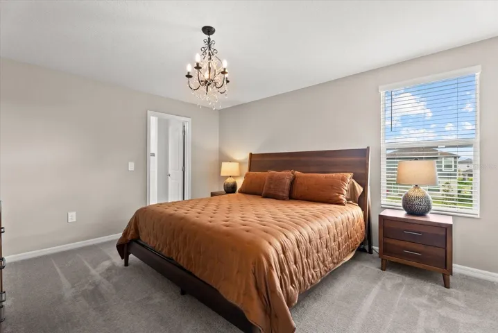 Generously sized primary bedroom with natural light and private bathroom access.
