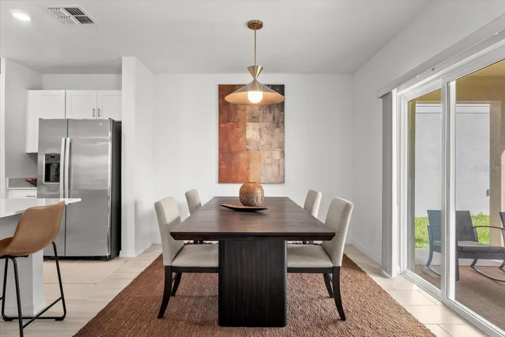 Dining area with sliding glass doors providing direct access to the backyard.