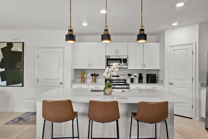 Expansive kitchen island offering generous preparation space and casual seating.