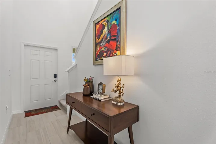 Welcoming foyer with tile flooring and a bright, neutral interior.