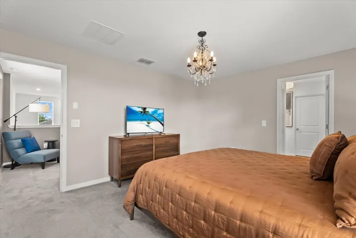 Primary suite with ample space for a full bedroom furniture set.