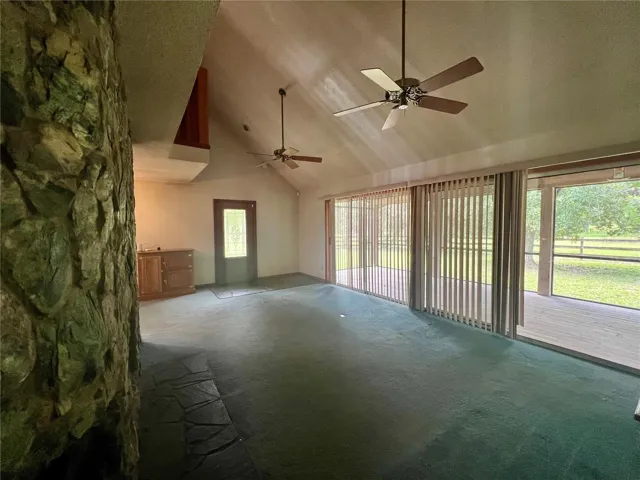 Living room with stone wood burning fireplace