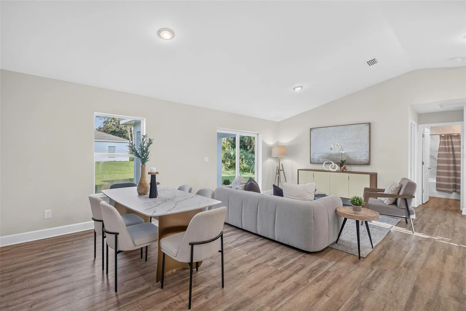 Staged dining area and living room view