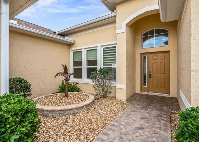 Covered front entrance w/sidelight accented front door
