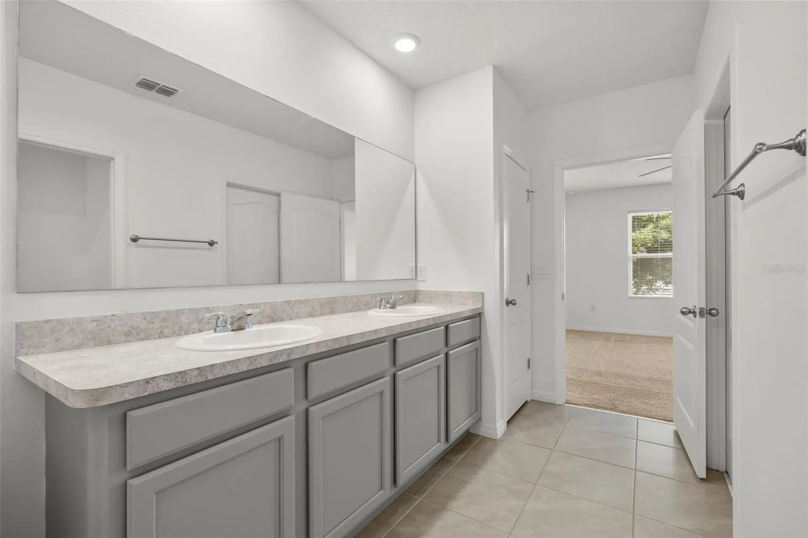 Additional view of the primary bath with ample vanity space.