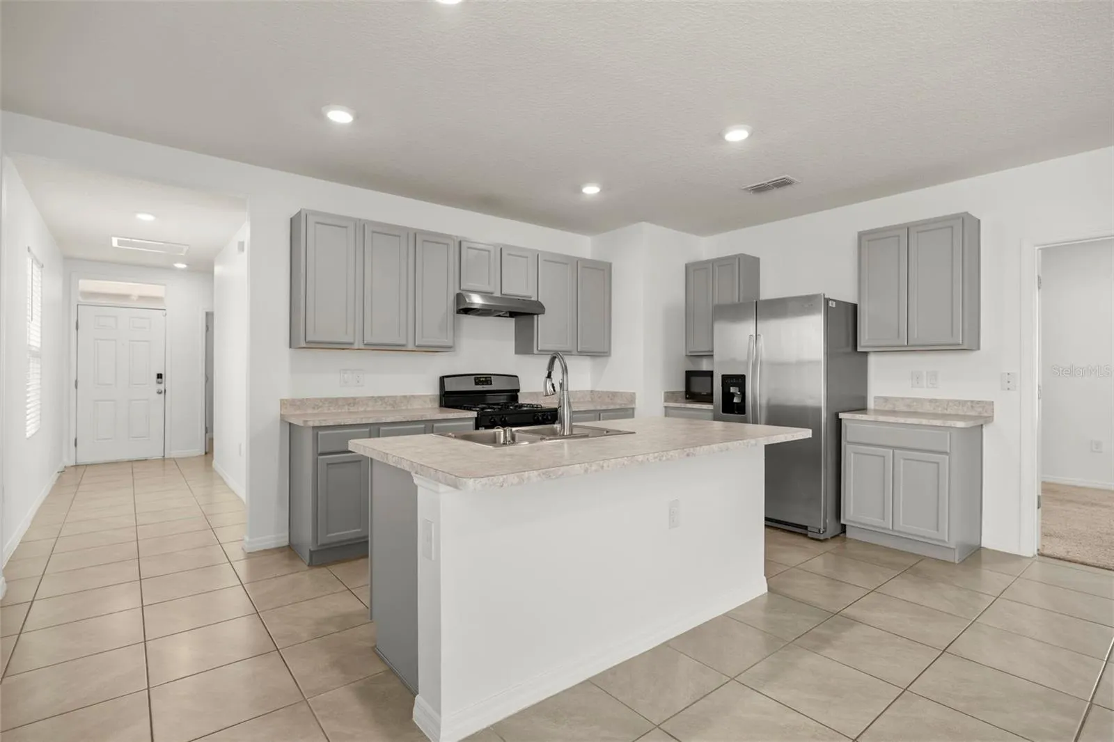 Large center island provides additional prep space and a natural gathering point.