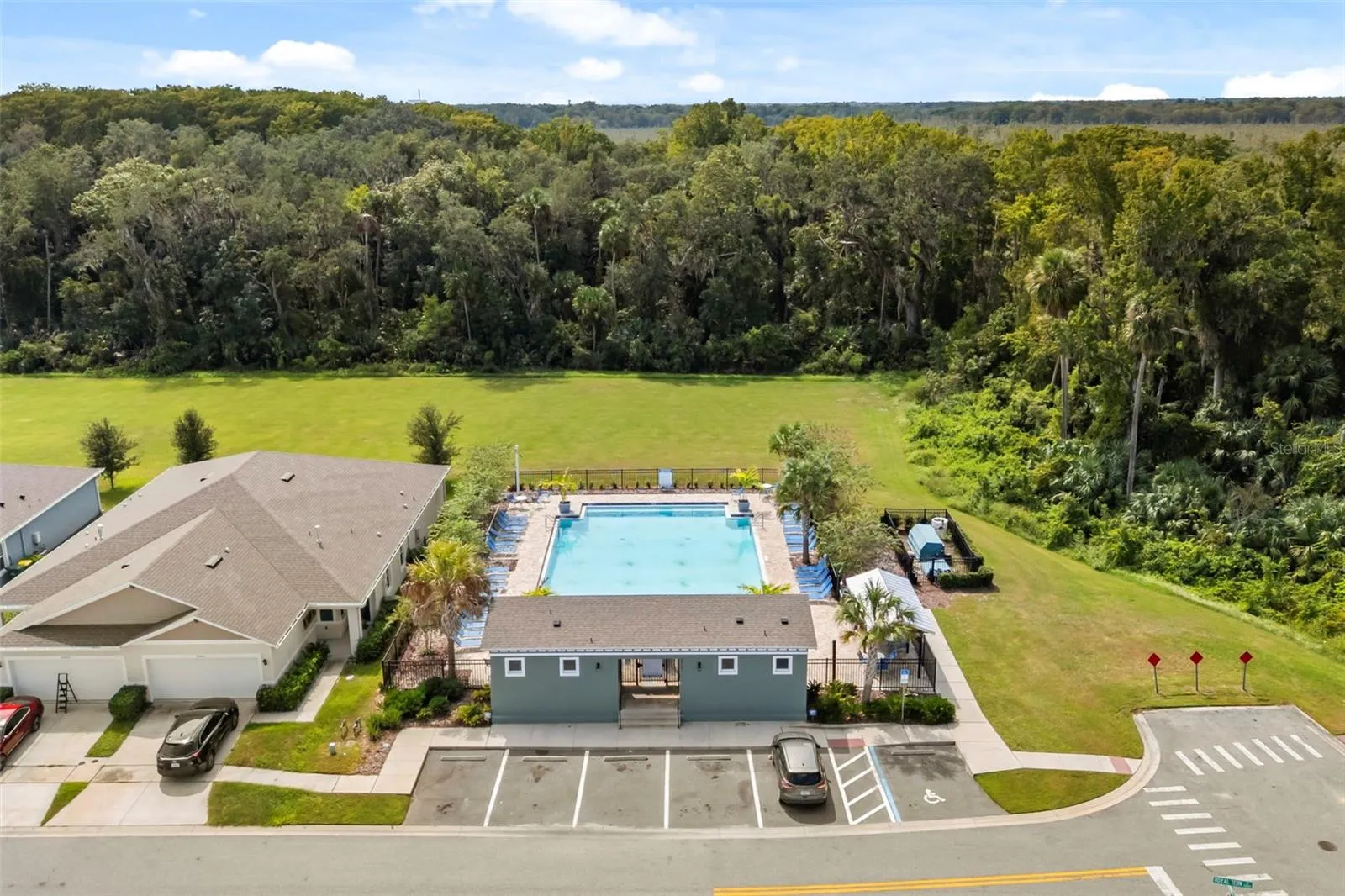 Community pool surrounded by green space and neighborhood amenities.