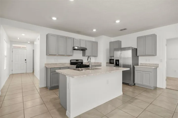Large center island provides additional prep space and a natural gathering point.