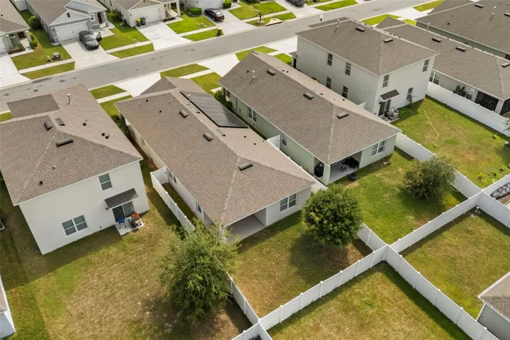 Aerial view of the home, backyard, and surrounding properties.