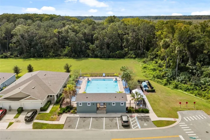 Community pool surrounded by green space and neighborhood amenities.