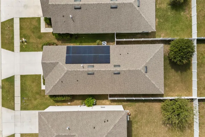 Overhead view showcasing the home’s solar panels and roofline.