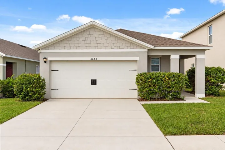 Beautiful curb appeal with a spacious driveway, 2-car garage, and inviting entry at 3658 Caspian Street.