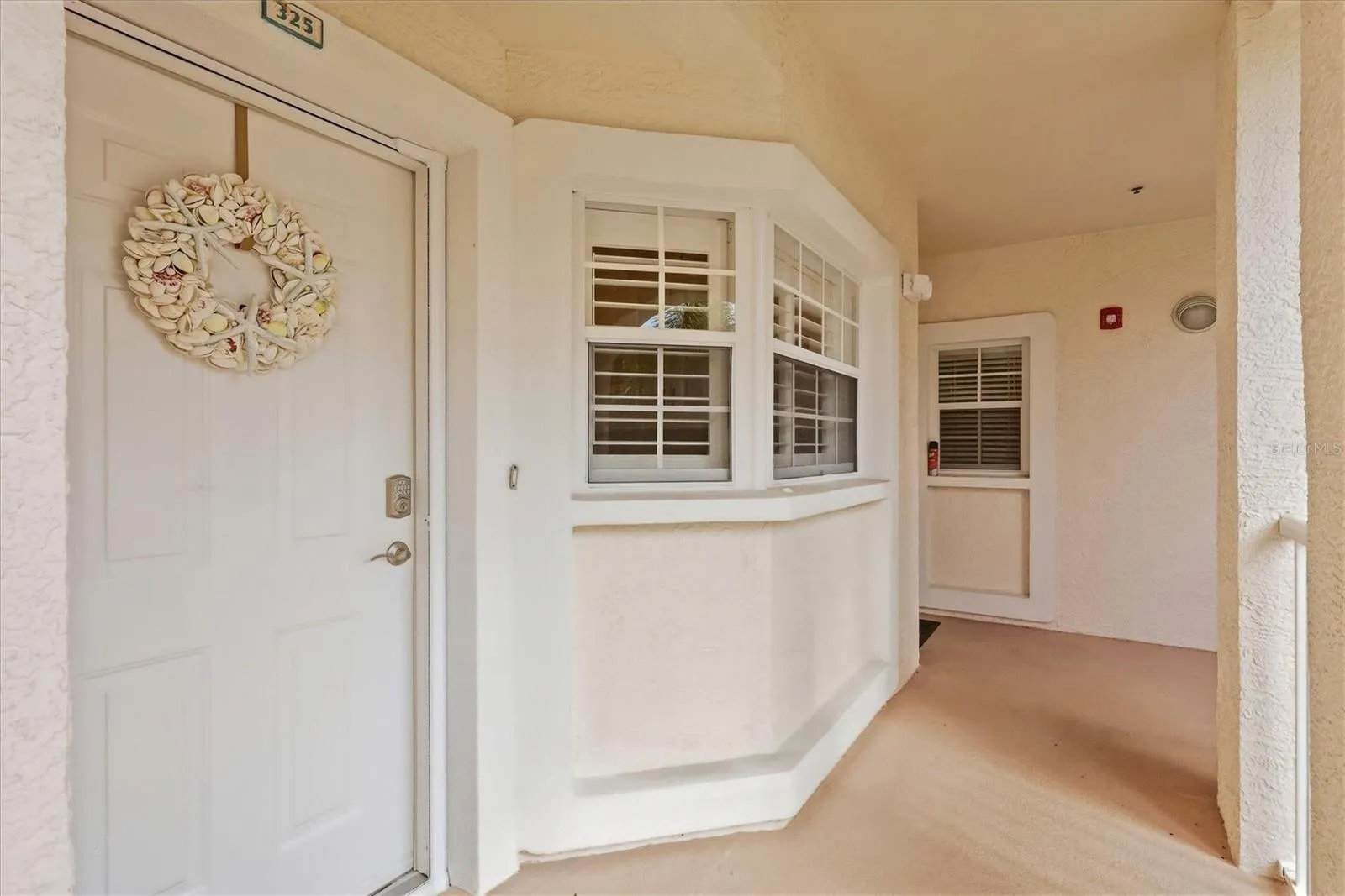 Front door and kitchen windows featuring Plantation Shutters.