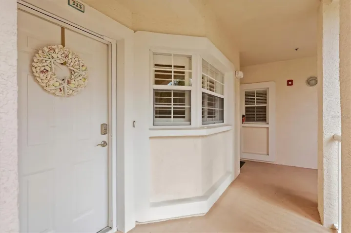 Front door and kitchen windows featuring Plantation Shutters.