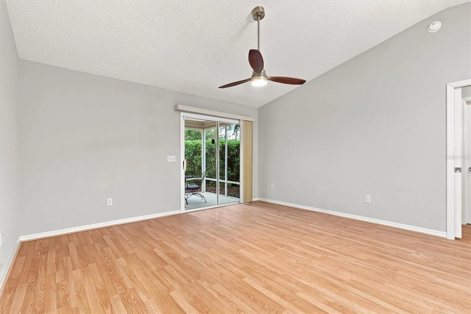 Living room: "Open living room with laminate flooring in The Villages Summerhill home"