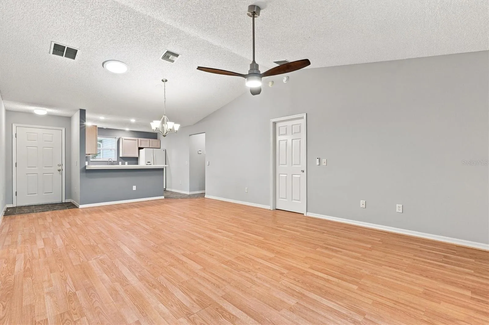 Living room: "Open living room with laminate flooring in The Villages Summerhill home"