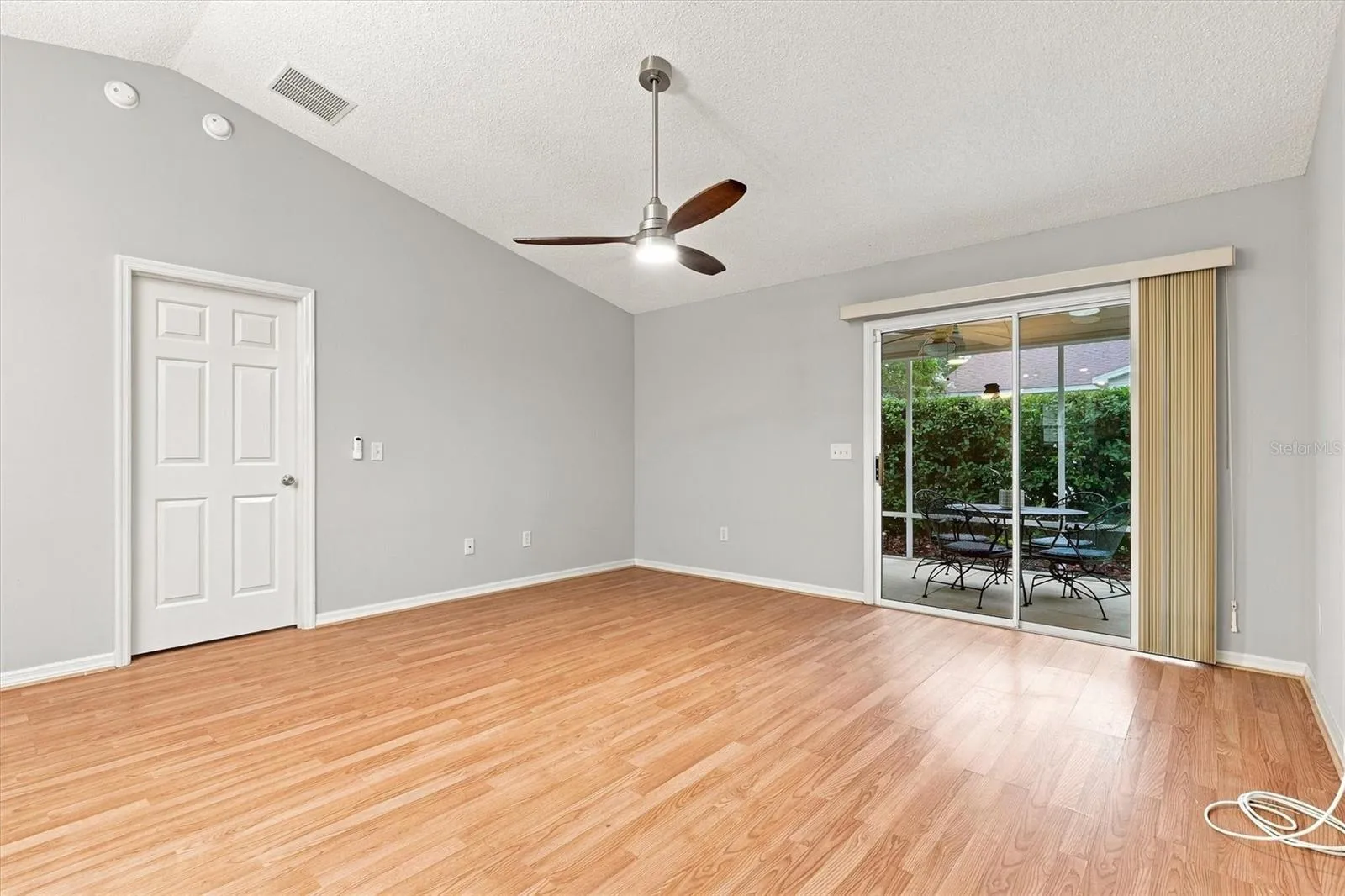 Living room: "Open living room with laminate flooring in The Villages Summerhill home"