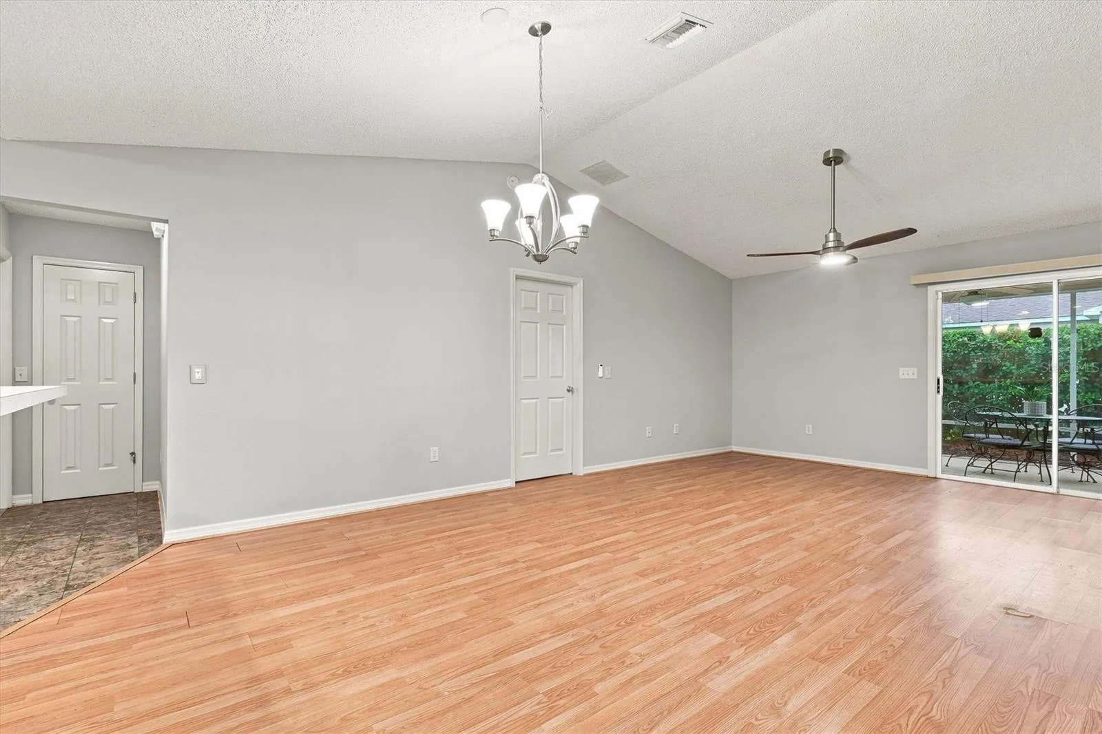 Living room: "Open living room with laminate flooring in The Villages Summerhill home"