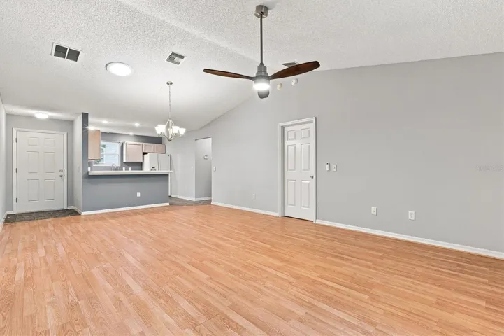 Living room: "Open living room with laminate flooring in The Villages Summerhill home"