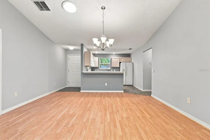 Living room: "Open living room with laminate flooring in The Villages Summerhill home"