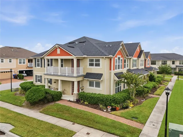Desirable end-unit townhome offering additional windows, enhanced privacy and extra green space along the side, complemented by a covered front porch, spacious second-floor balcony and charming architectural details.